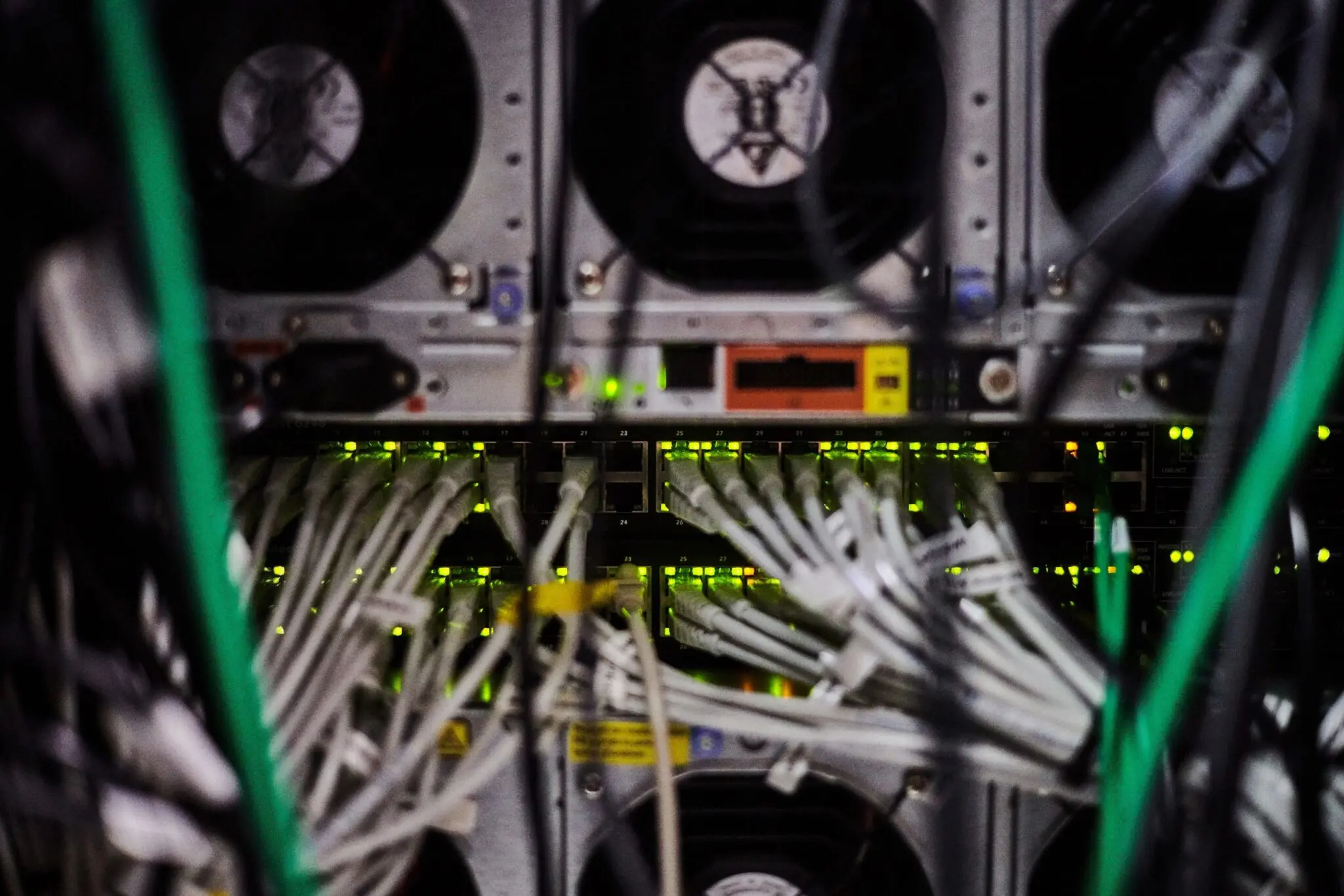 Server room with cables and equipment.
