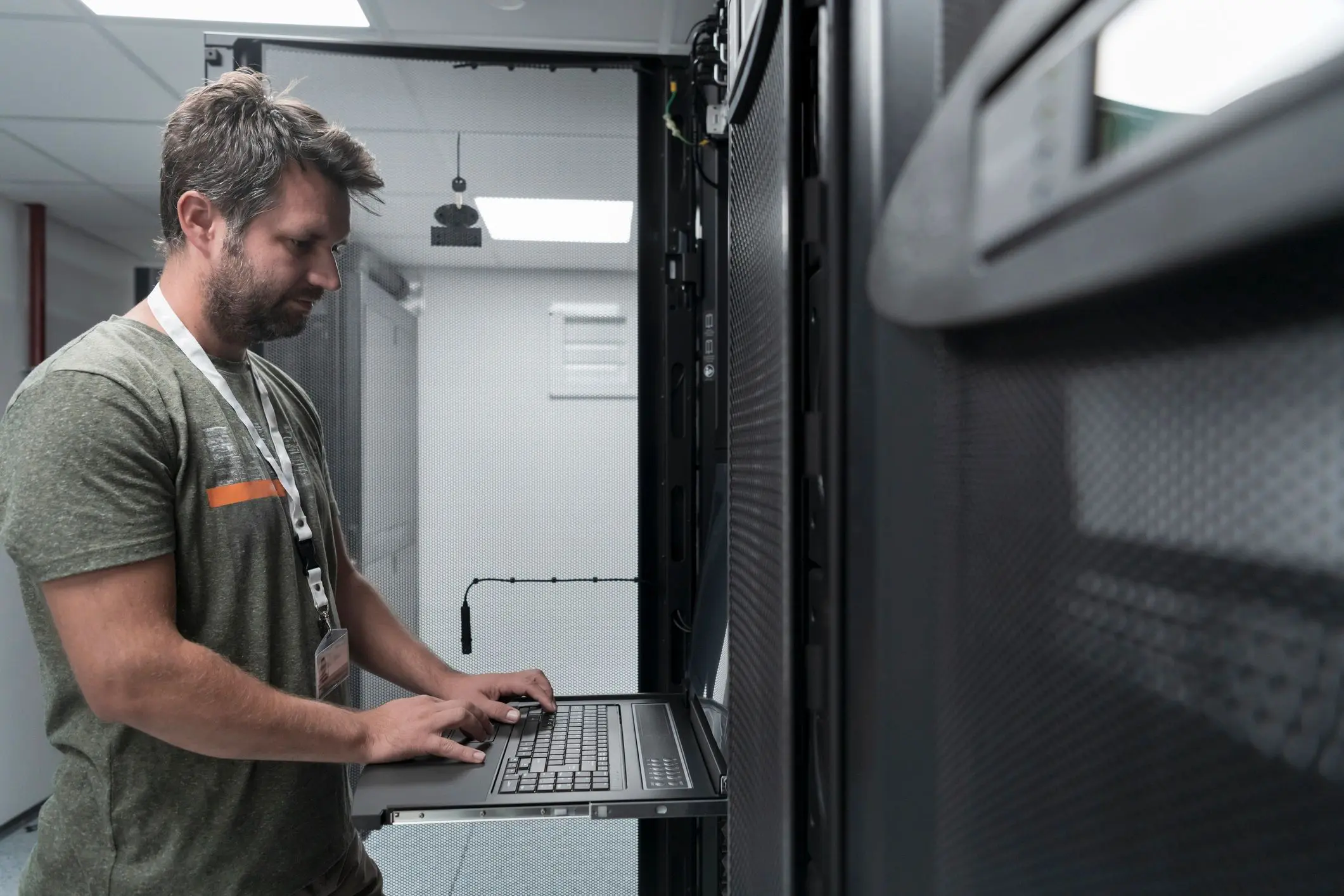 Man working on server in data center.