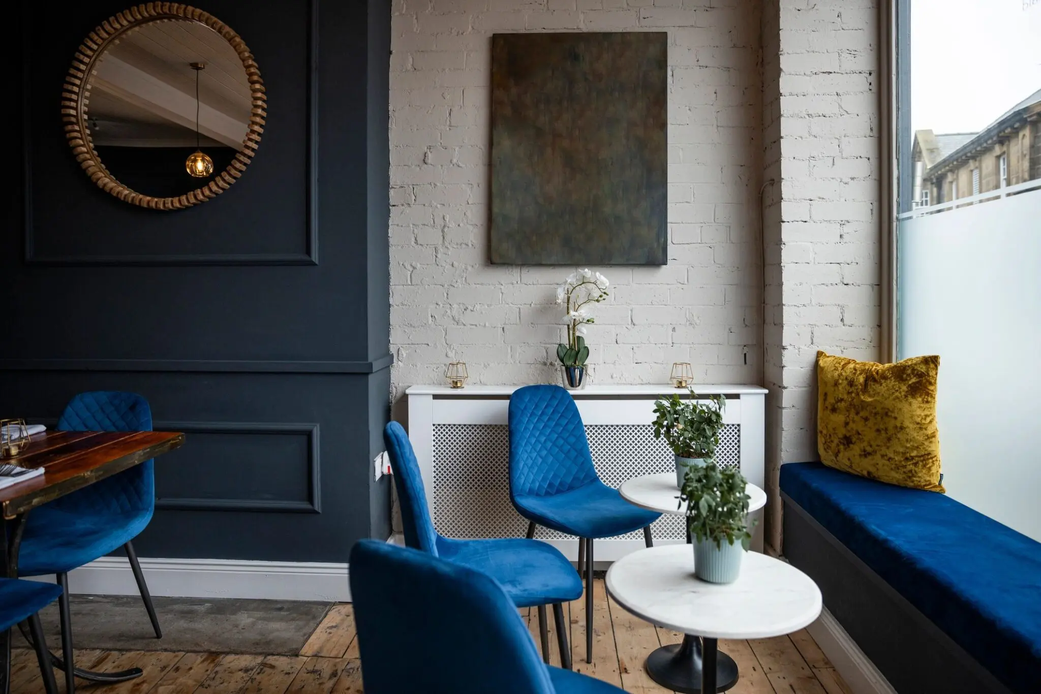 Cozy cafe seating with blue chairs.