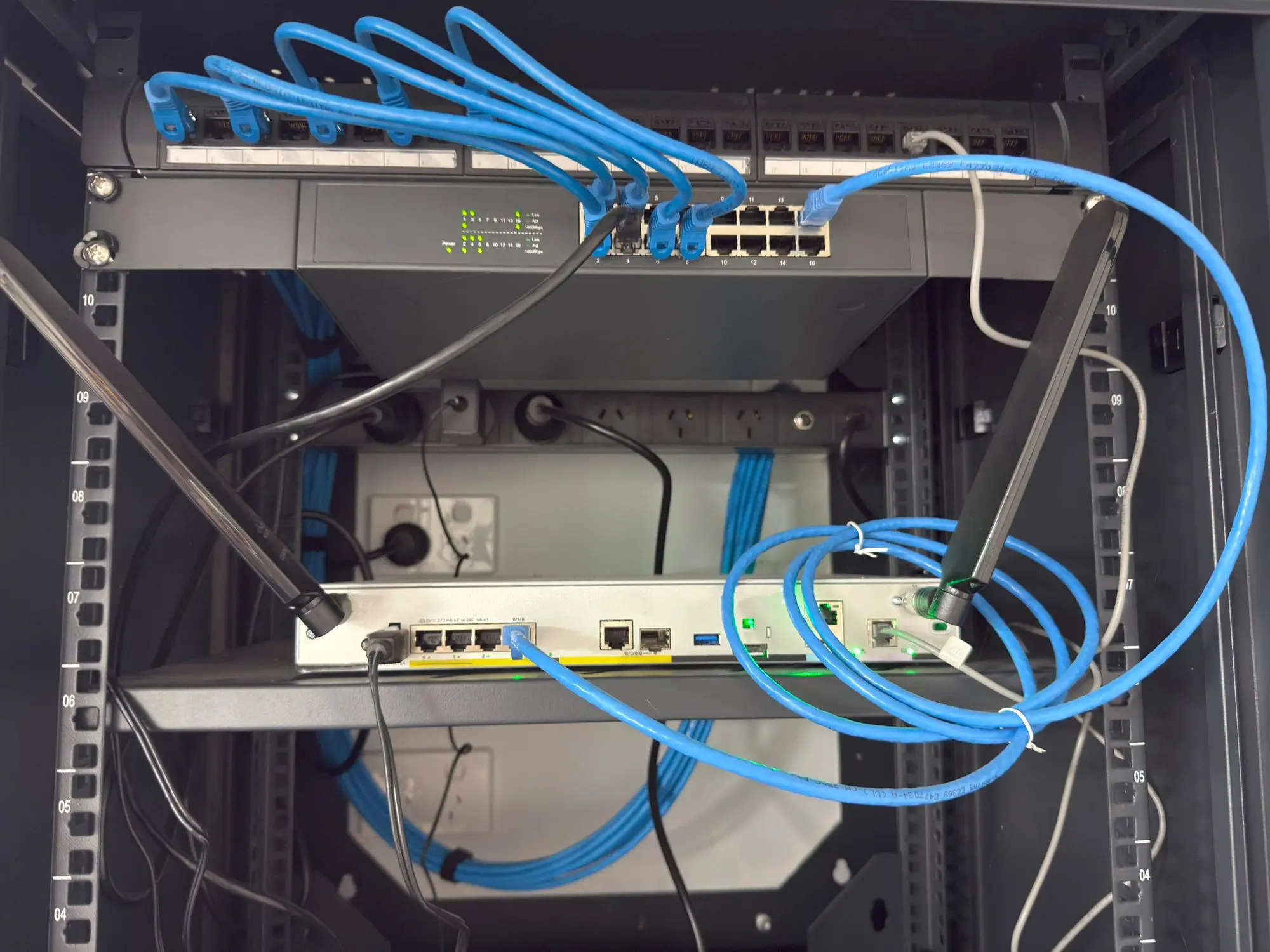 Network server rack with blue Ethernet cables.
