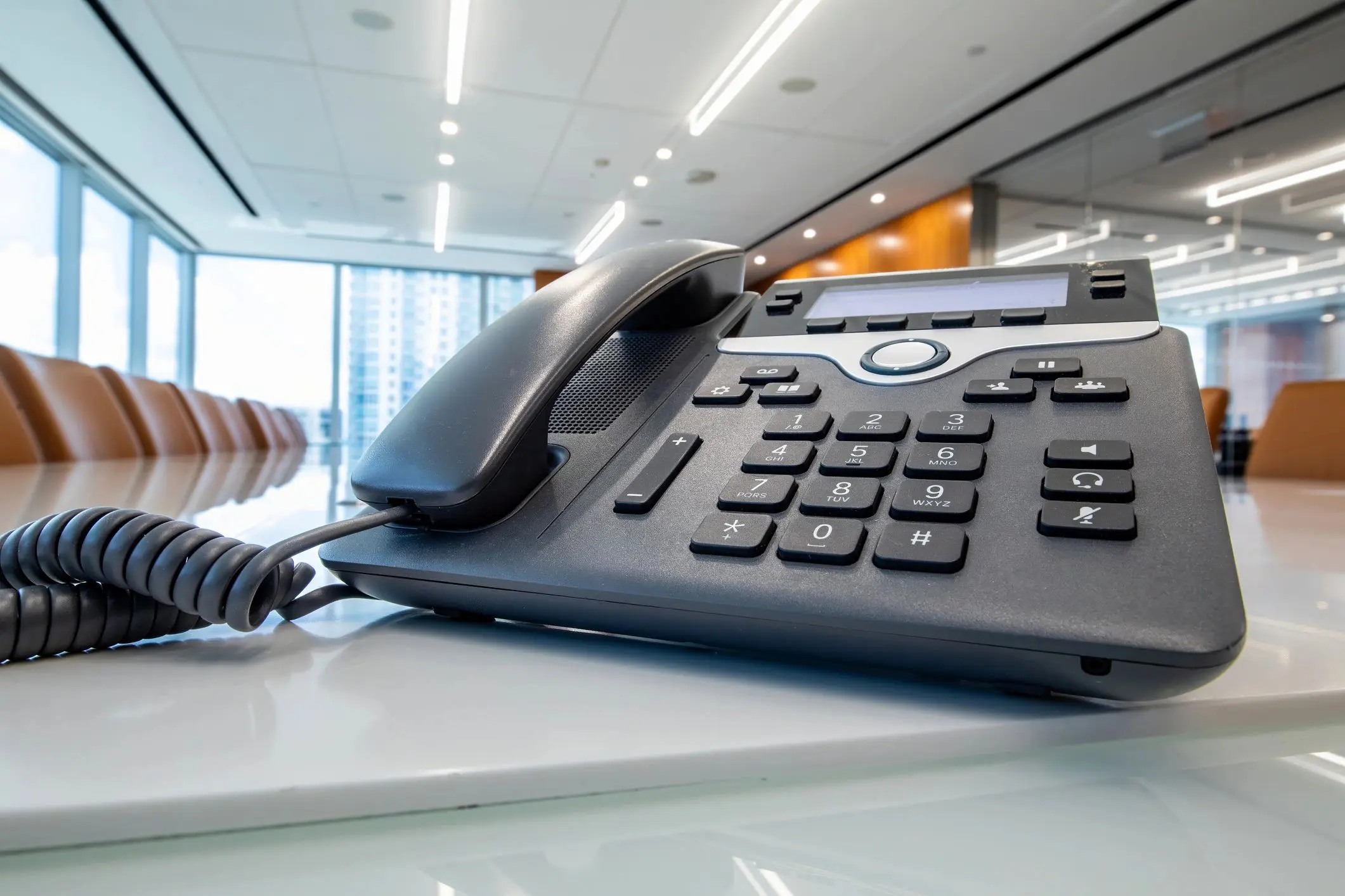 Office conference room with a desk phone.