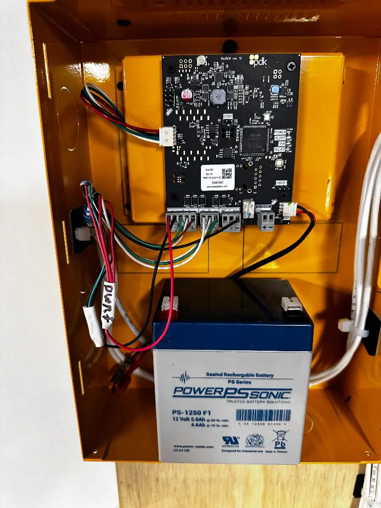 Open control box with circuit board and battery
