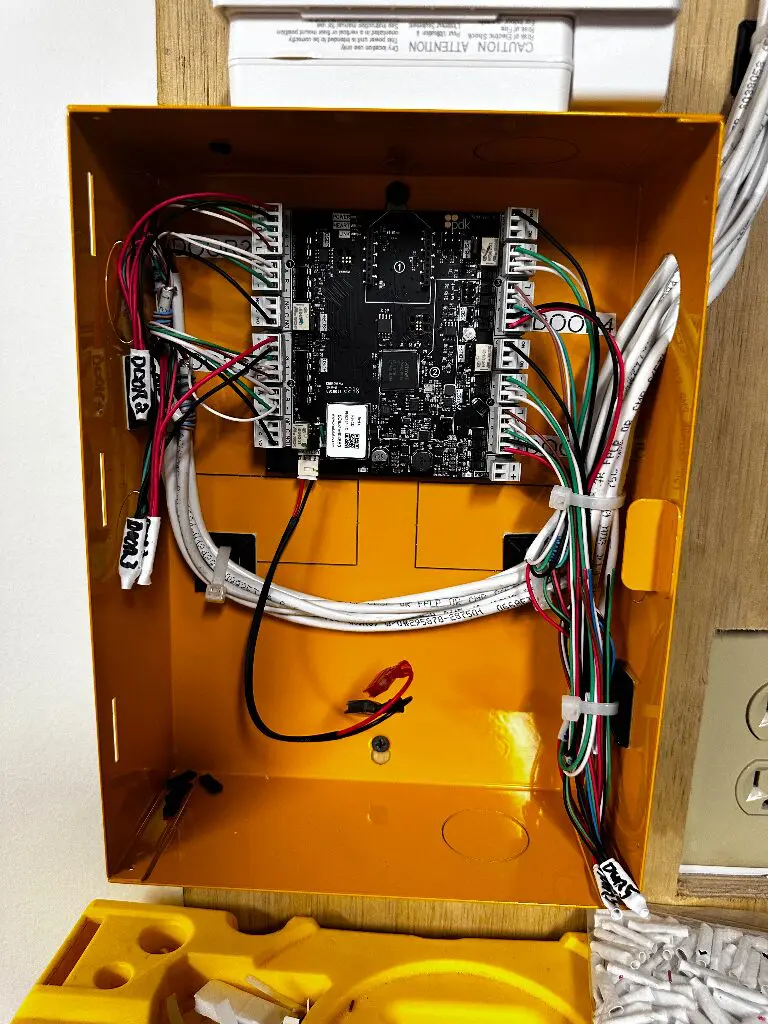 Open yellow electrical box with circuit board