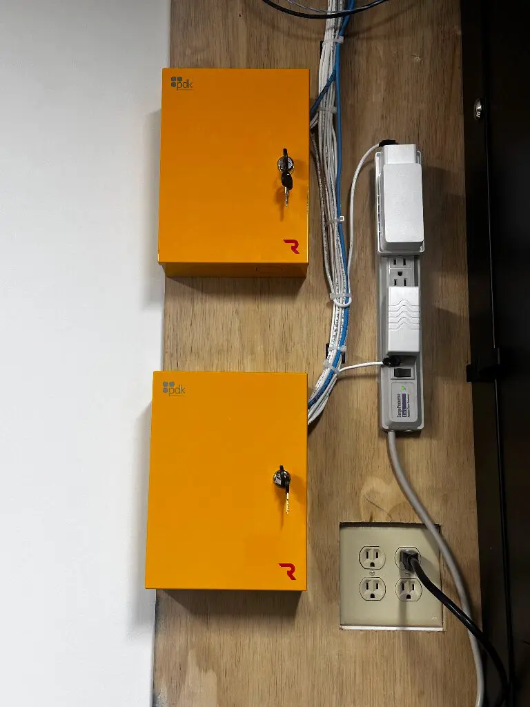 Two orange lockable network boxes with cables