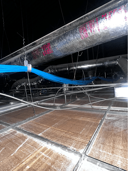 Exposed ceiling plenum with ducts and cables