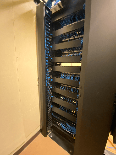 Vertical server rack with organized blue network cables
