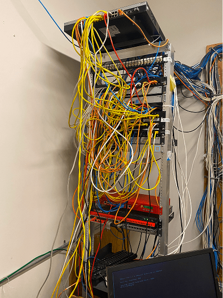 Messy server rack with tangled network cables