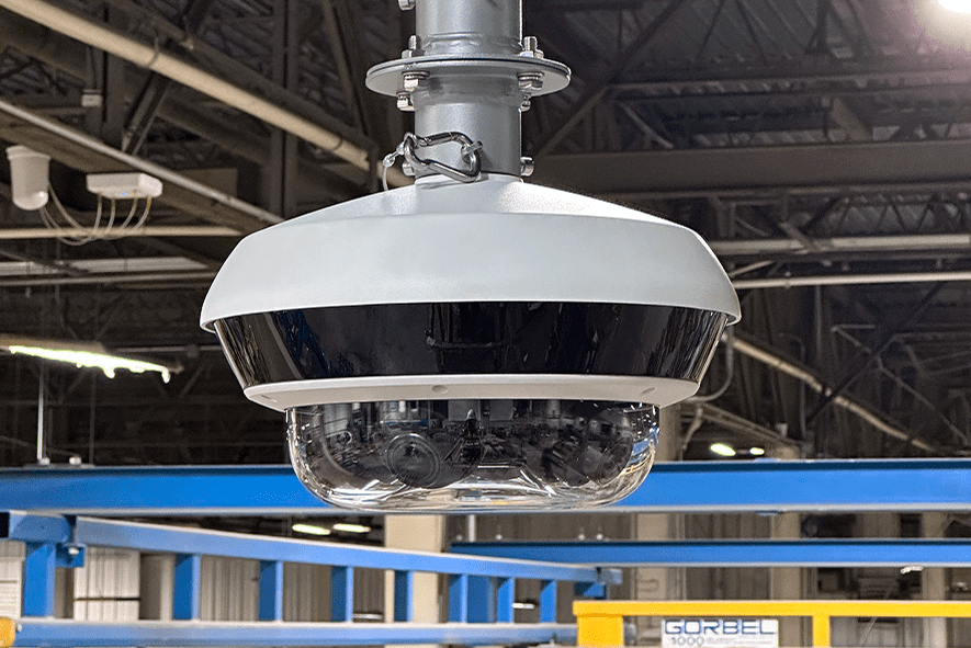 Ceiling-mounted dome security camera in warehouse