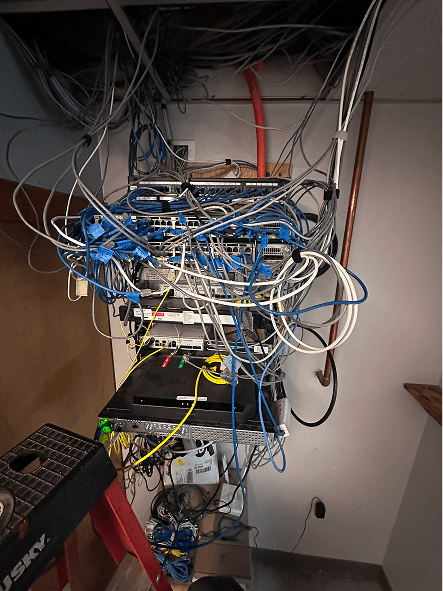 Messy network rack with tangled ethernet cables