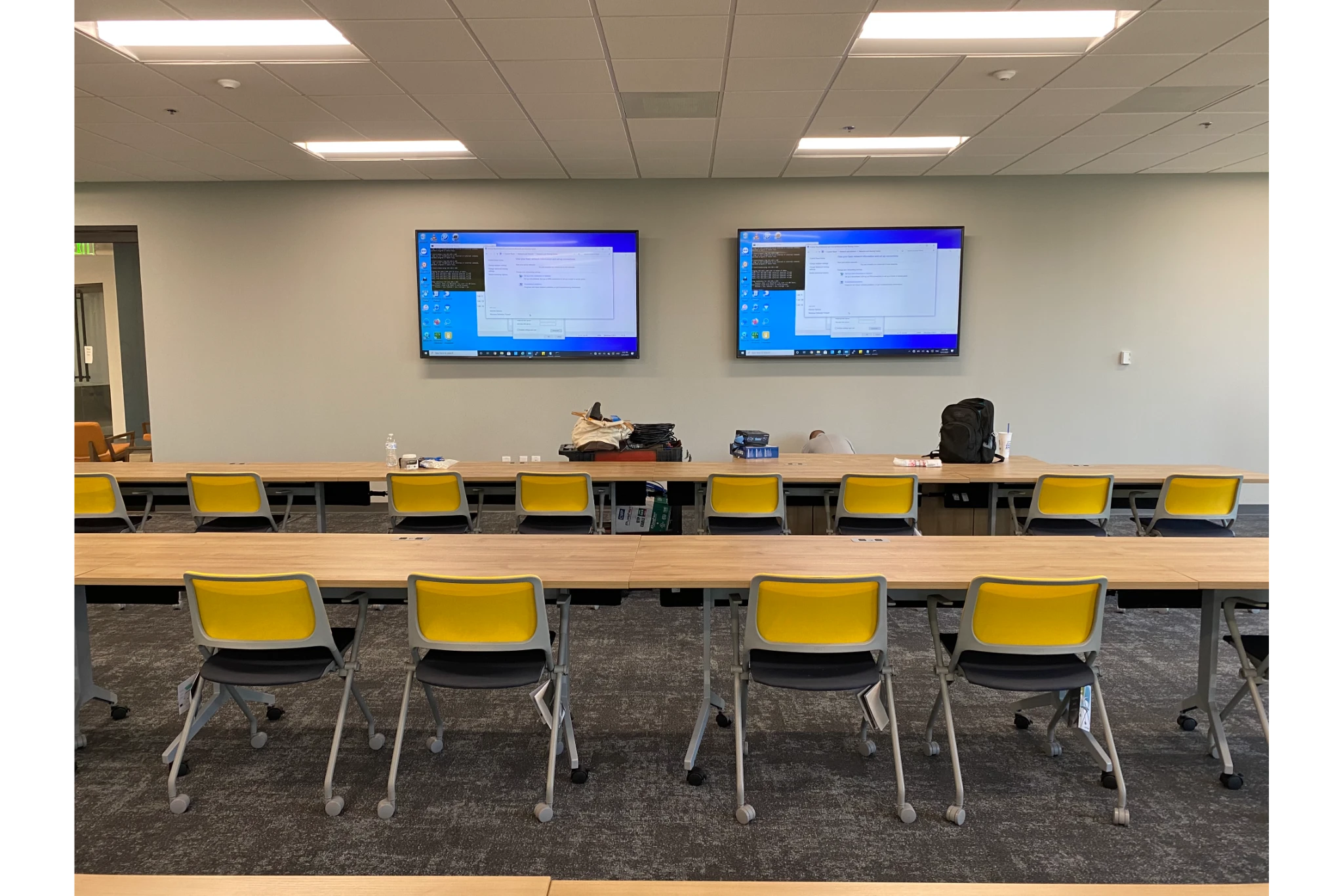Training room with yellow chairs and wall monitors