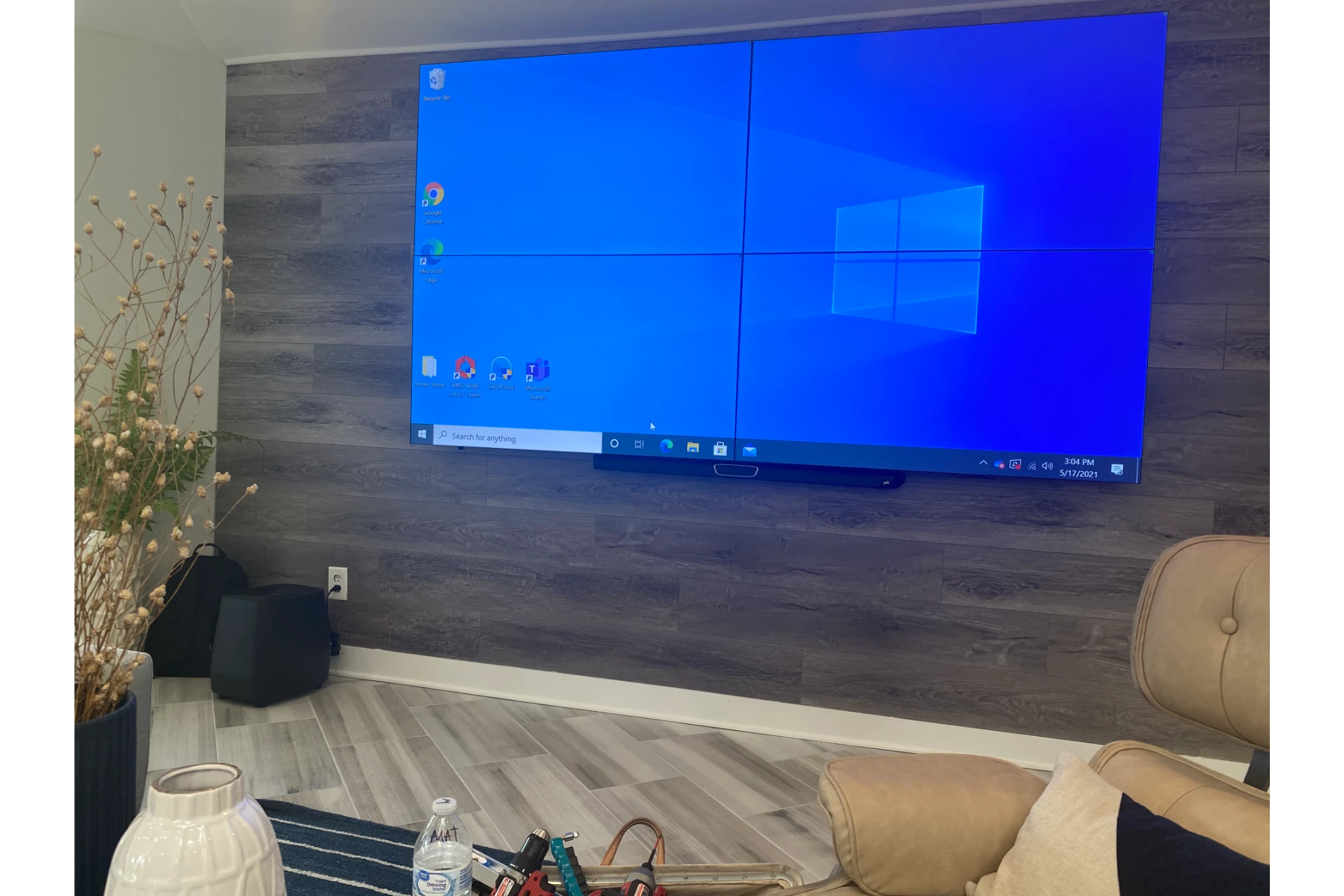 Wall-mounted multi-panel TV showing Windows desktop