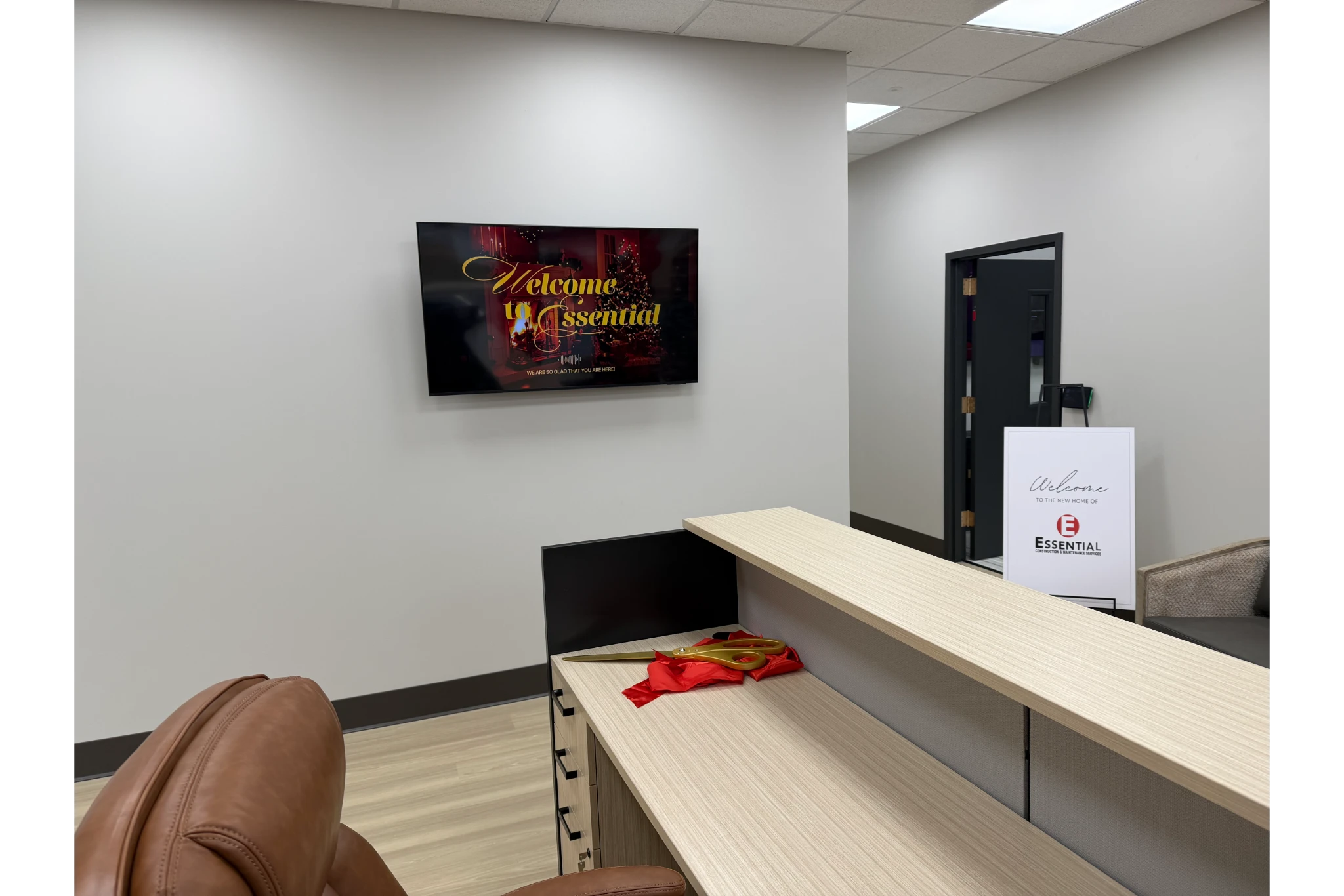 Modern office reception desk with welcome screen