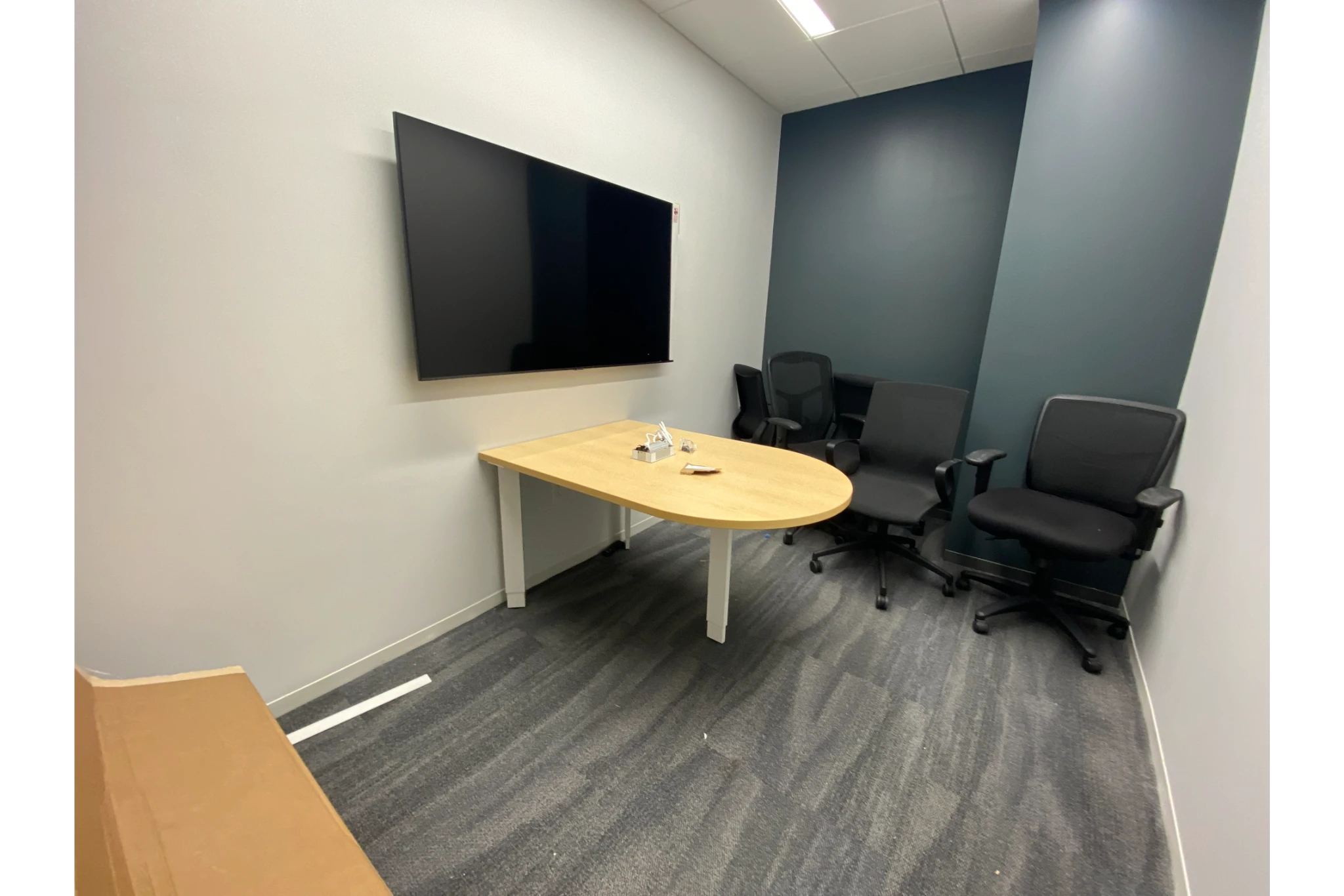 Small meeting room with TV and chairs