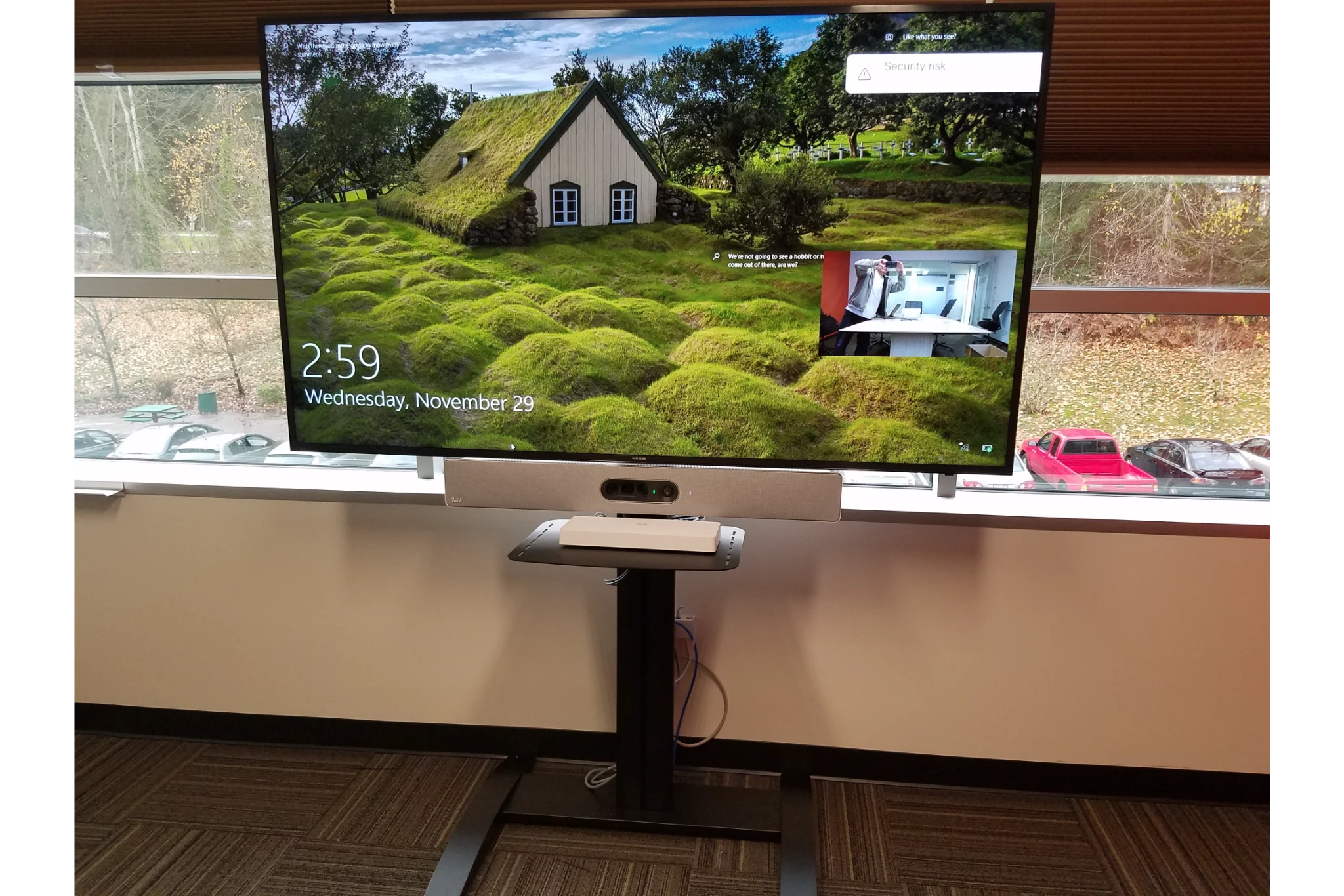Flat-screen monitor on stand showing landscape wallpaper