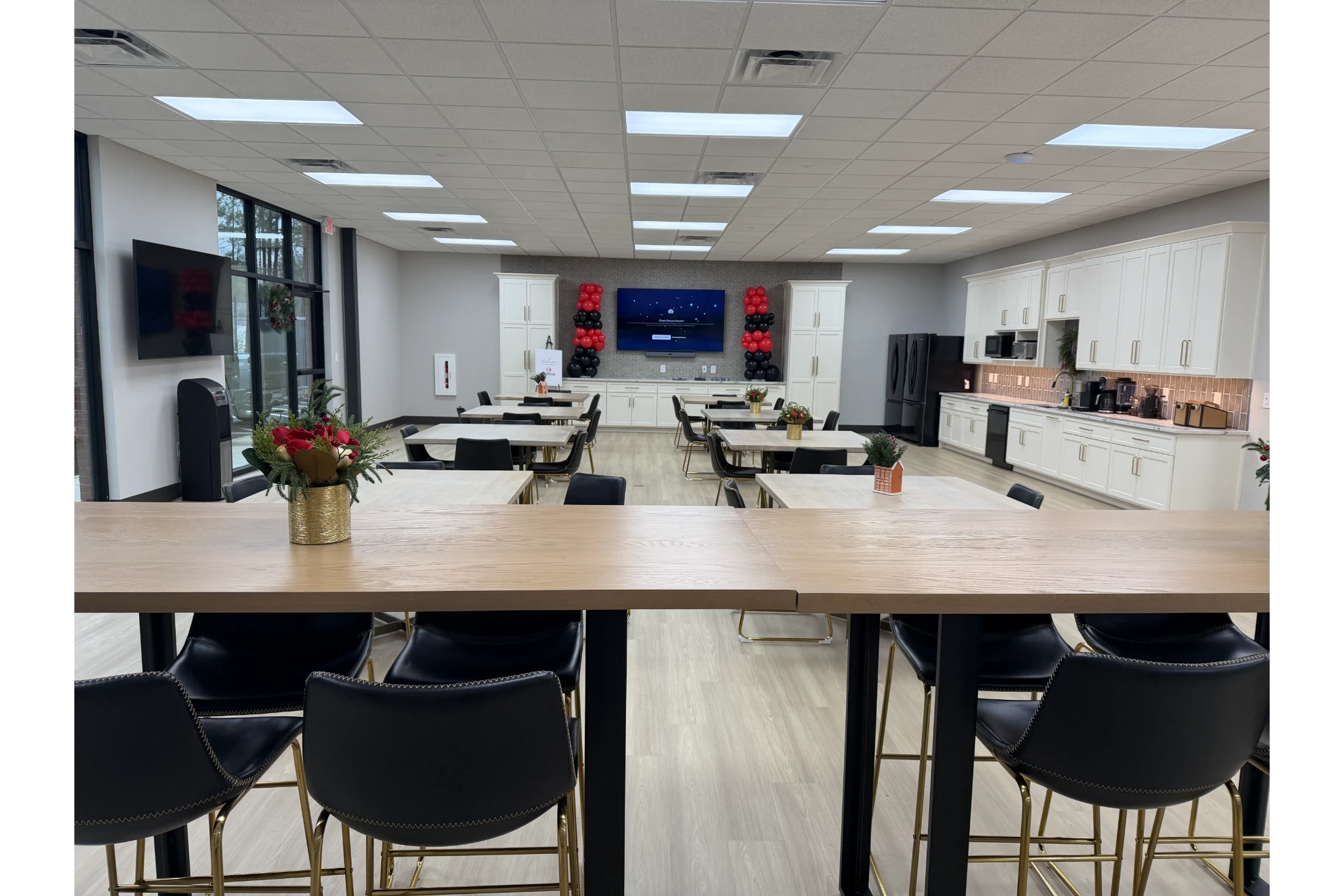 Modern office breakroom with seating and kitchenette