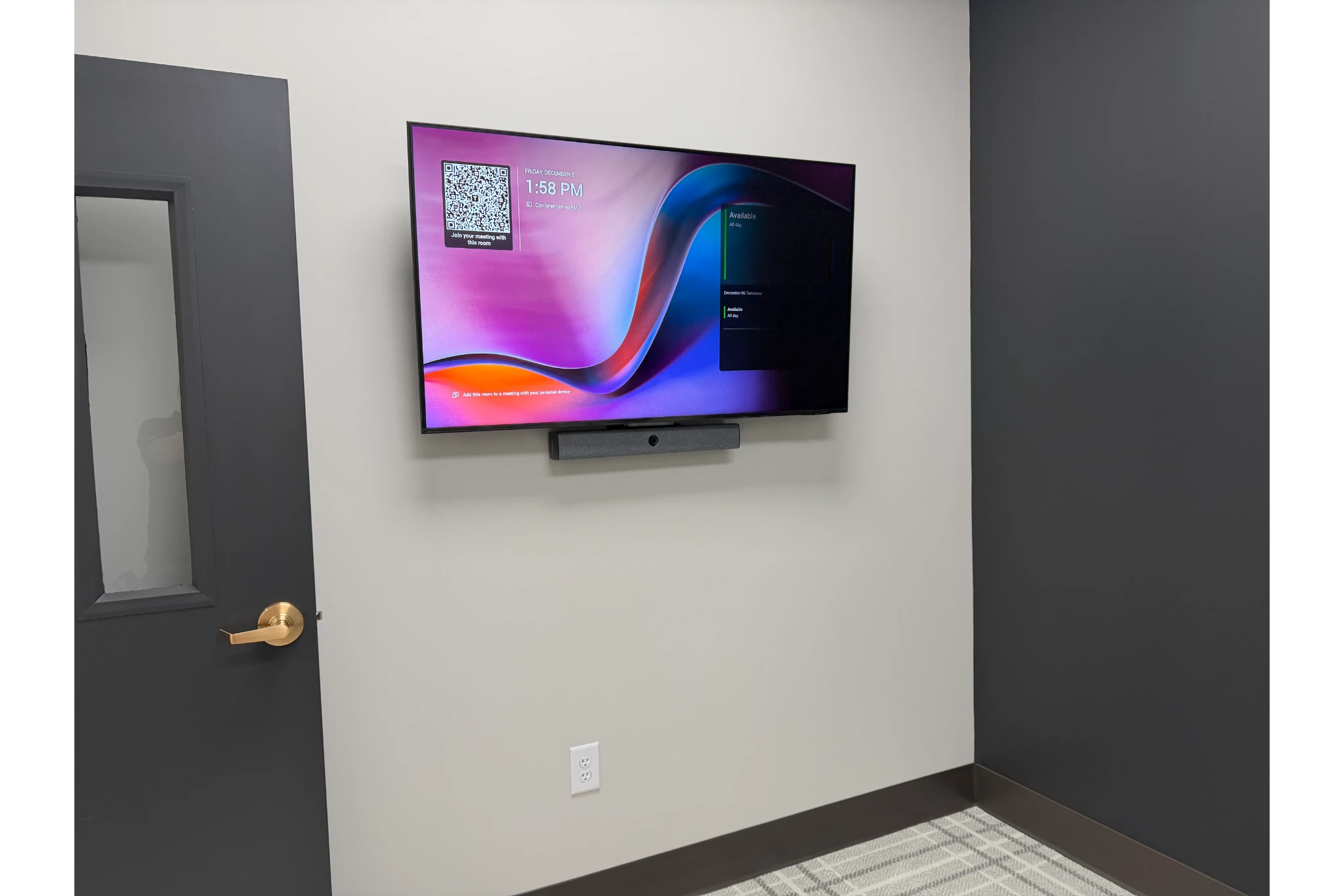Wall-mounted TV with soundbar in office