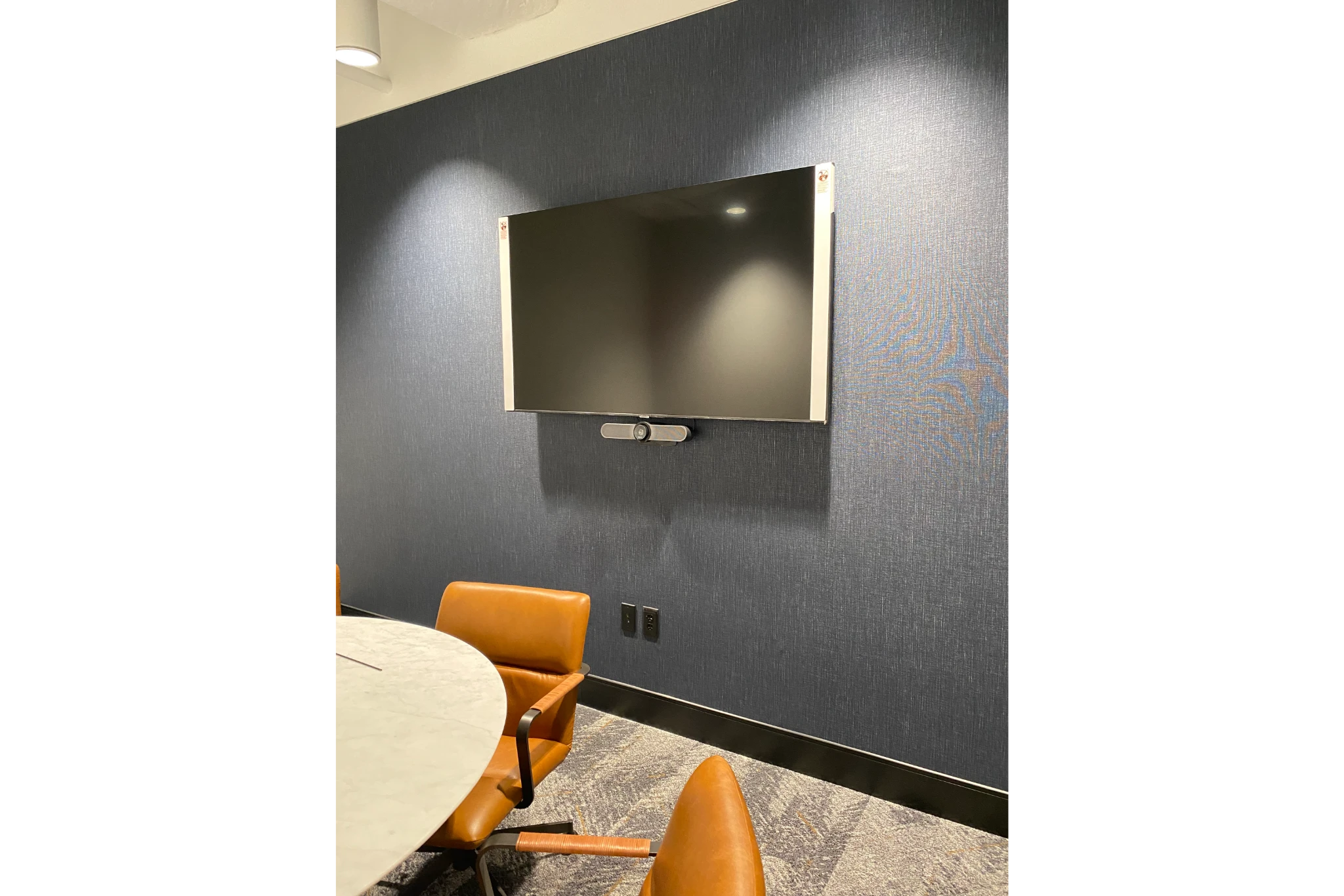 Conference room with wall-mounted TV and chairs