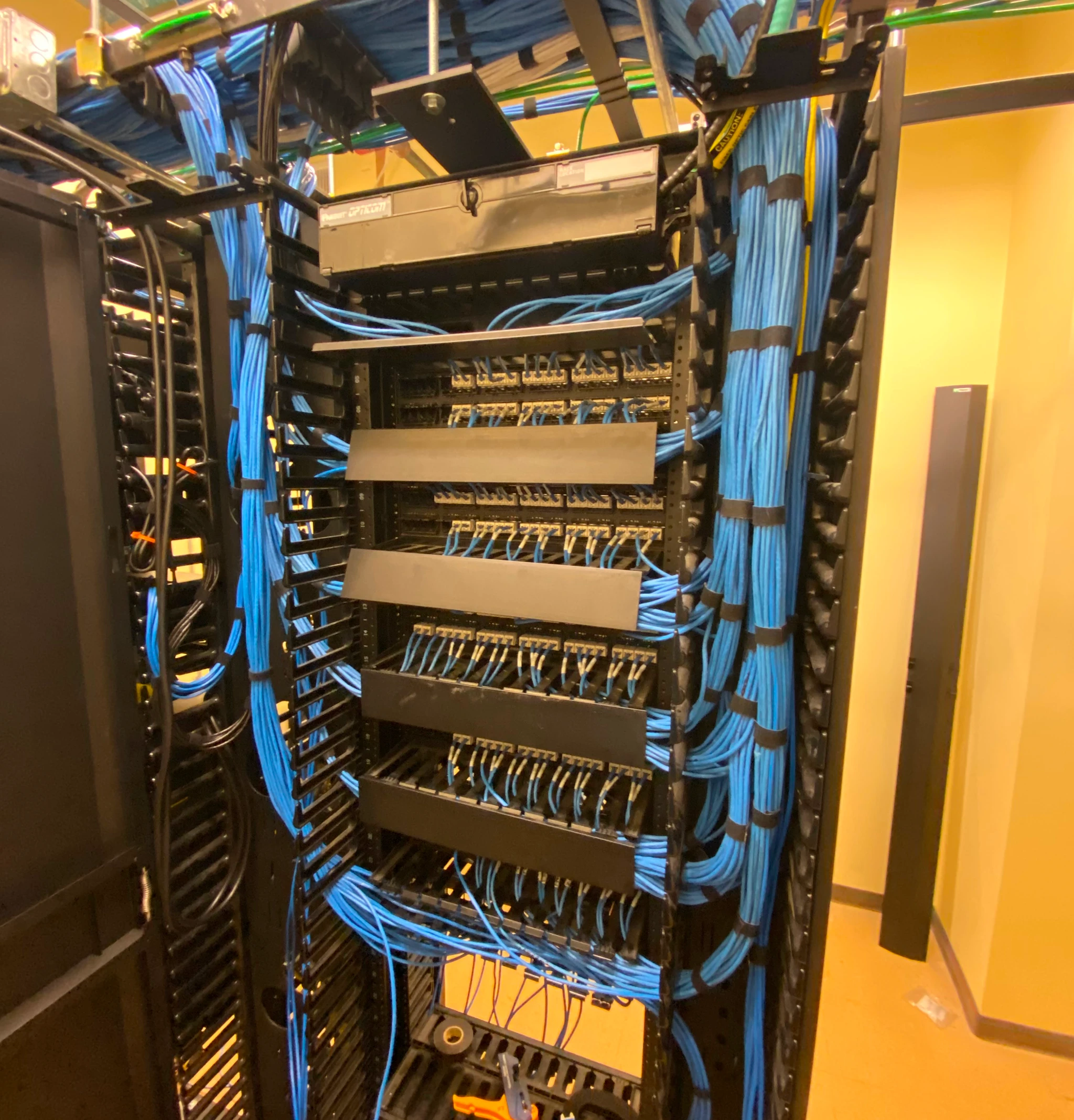 Server rack with organized blue Ethernet cables