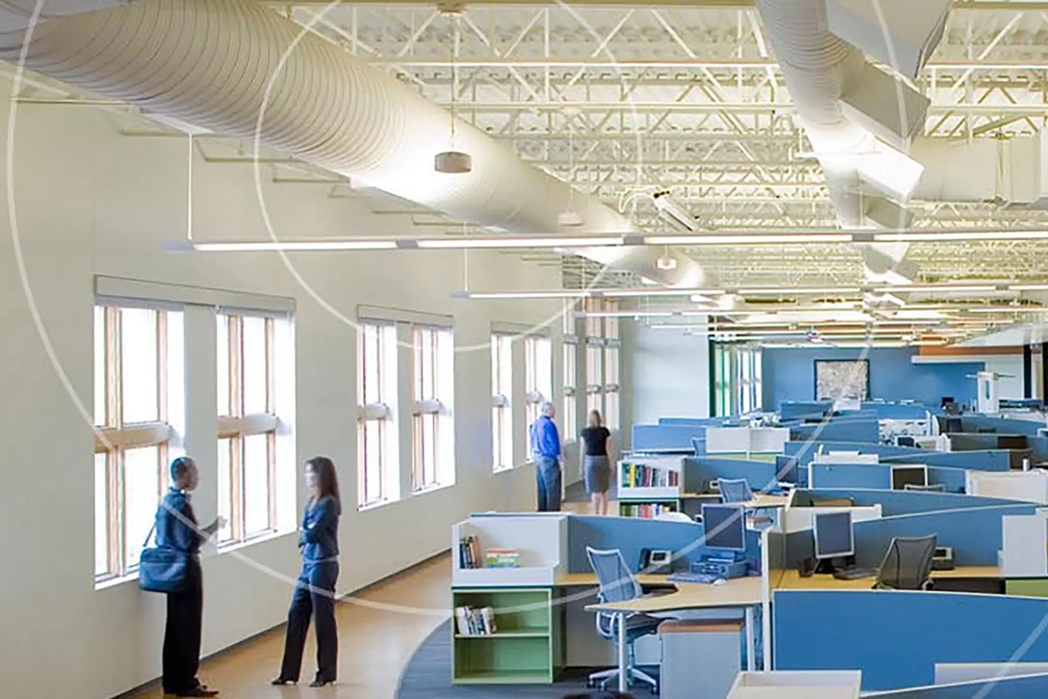 Modern open office with cubicles and people