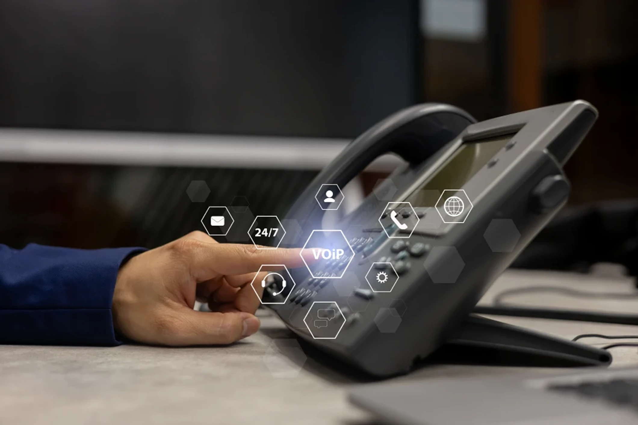 Hand using VoIP office desk phone