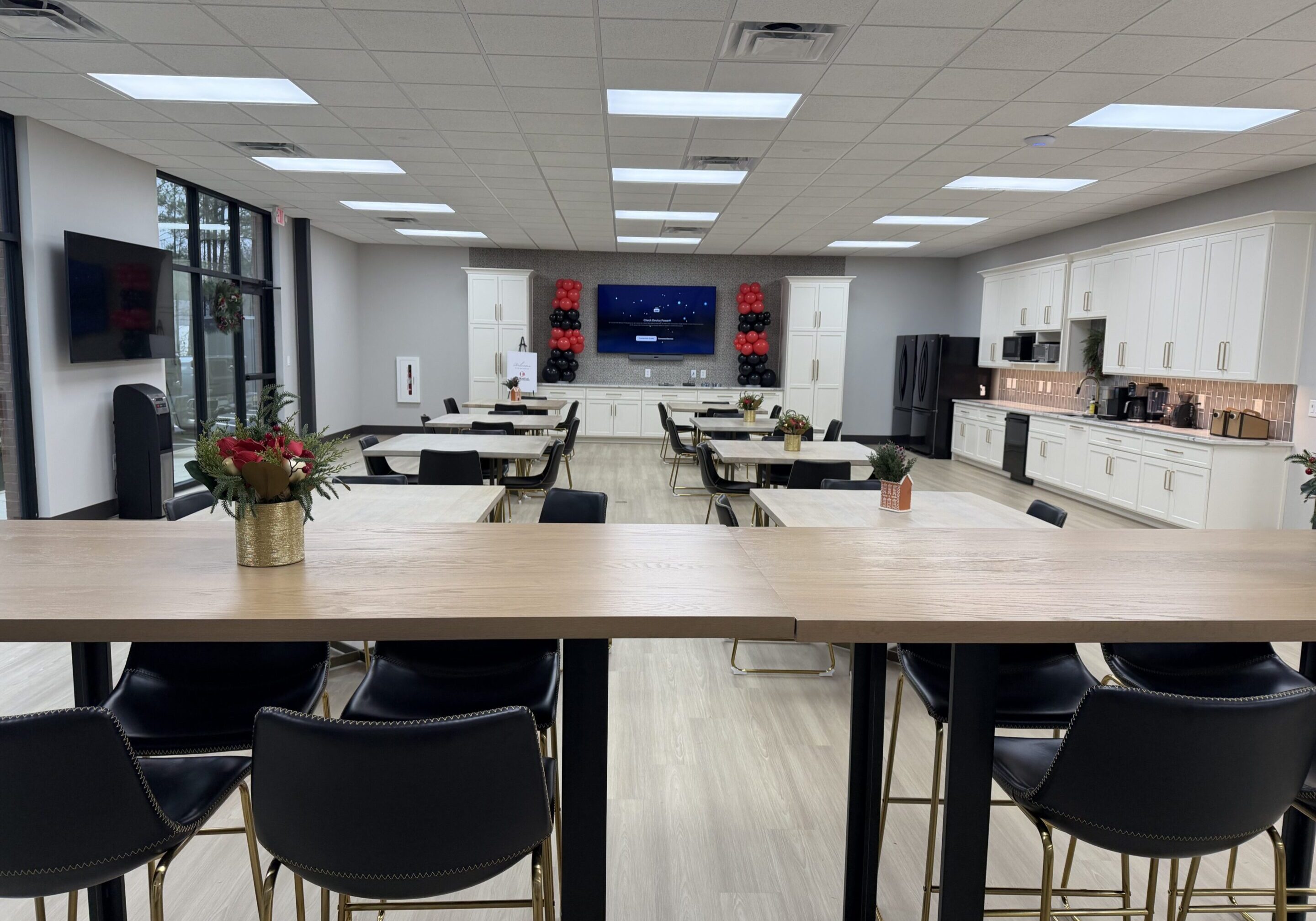 Modern office breakroom with kitchenette and seating